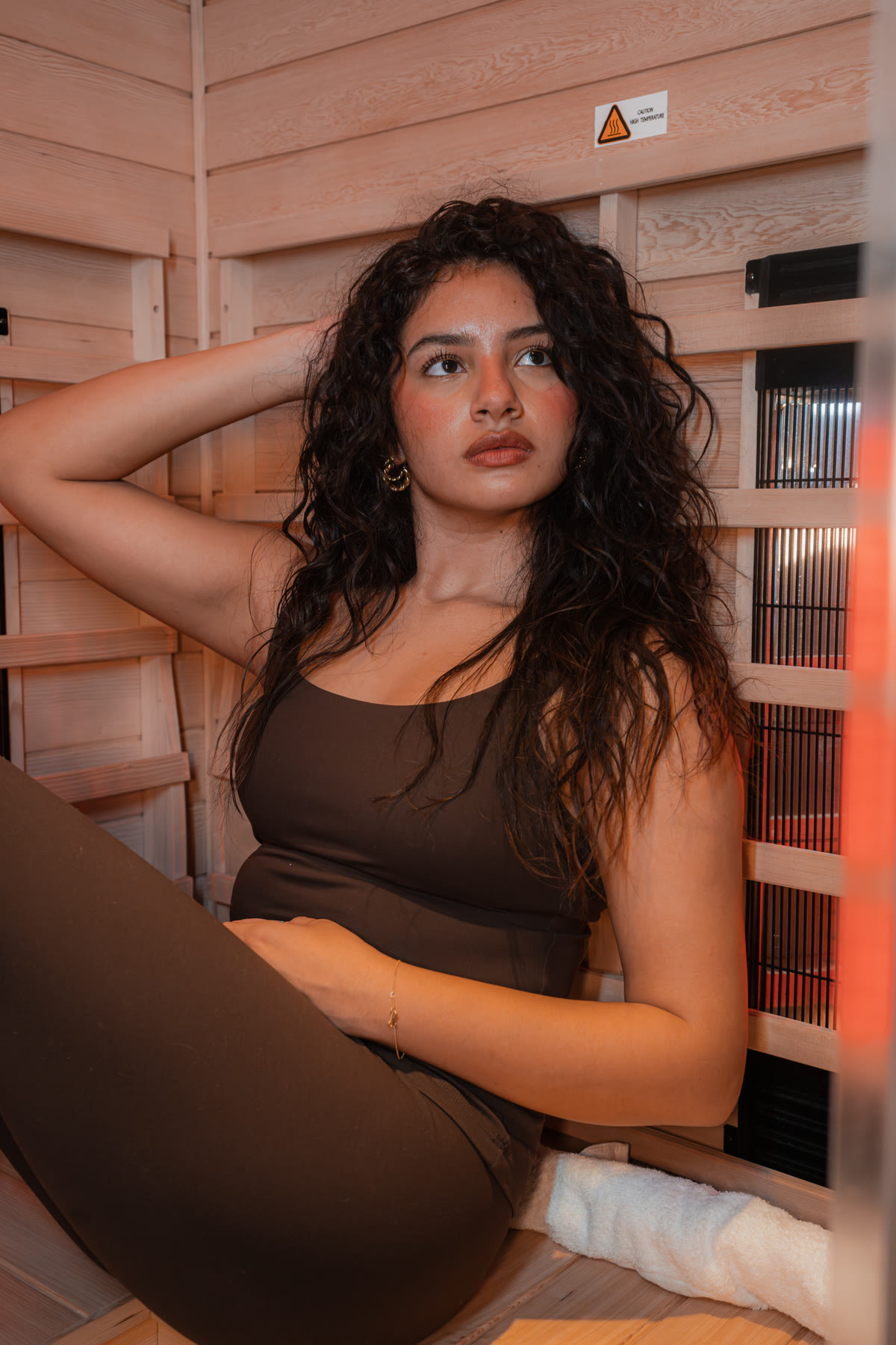 A client seated inside the infrared sauna